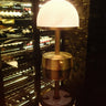 Mini Art Deco Cordless Lamp Antique Brass illuminating a room