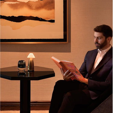  Owl 3 cordless lamp on a restaurant table, providing soft, ambient light, rechargeable.