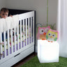 White Cube lamp (14 in) beside a white crib with flowers on top of the cube
