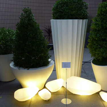 Large Oluce Stones outdoor lamp creating ambient terrace lighting