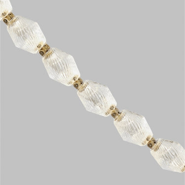 Collier 48 LED crystal pendant light, natural brass finish, modern living room installation.