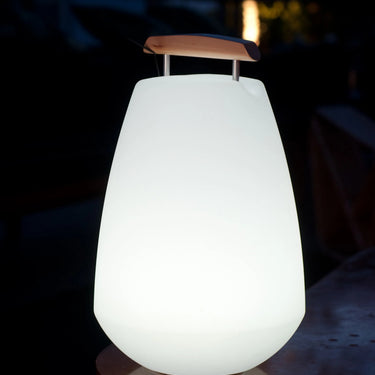 Vessel 2 Bluetooth LED Cordless Lamp by Smart & Green in white with a wooden handle at night - LoftModern