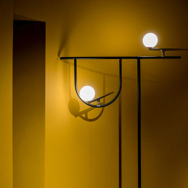 Artemide Yanzi artistic floor lamp inspired by swallows with opal glass globes and brass details