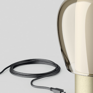 Kelp-colored Lodes Easy Peasy lamp with brushed rose base, used as a cozy reading light.