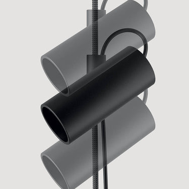 Lodes Cima plug-in pendant light with black head and gold rope, styled in a modern living room.